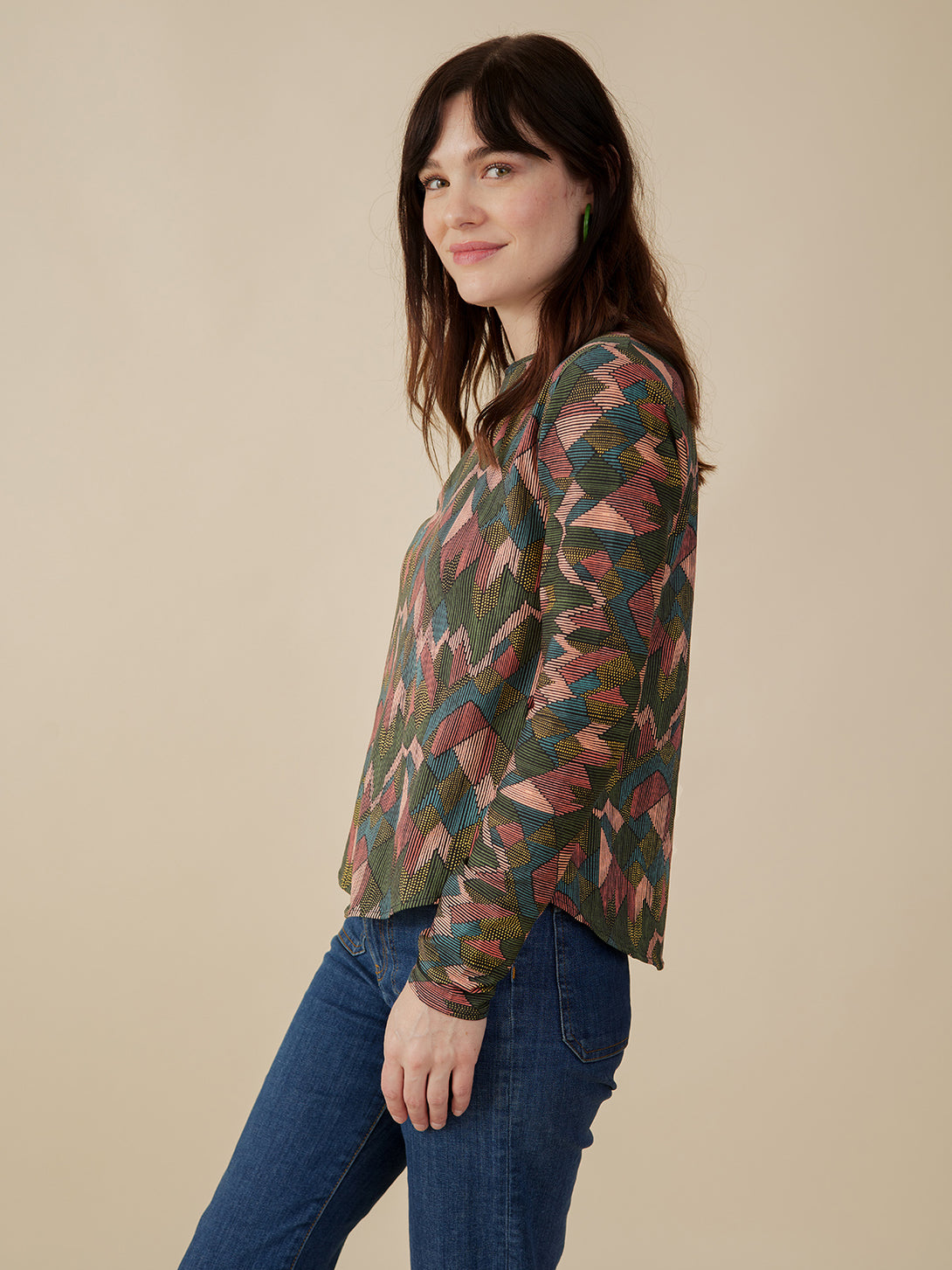 Model side view of sleeves Organic cotton fall stretch top in muted colors abstract jewel print - Mata Traders 
