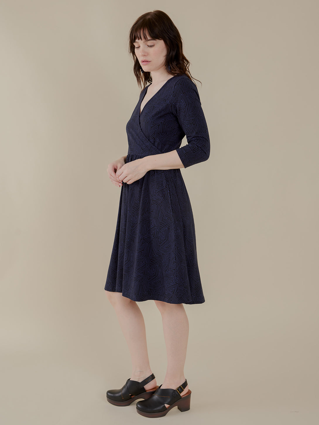 Side view model in organic cotton navy blue wrap dress 3/4 sleeve side view - Mata Traders 