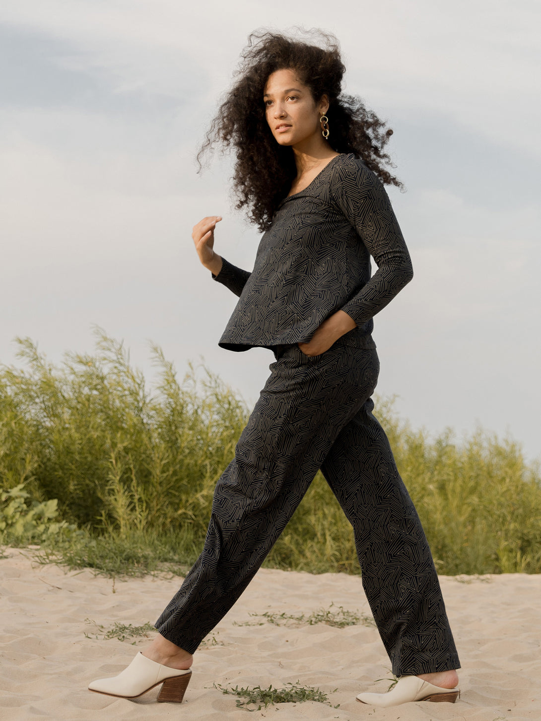 Model walking on sand wearing Grey Jersey Pants and Matching Long Sleeve Cotton Jersey Top - Mata Traders